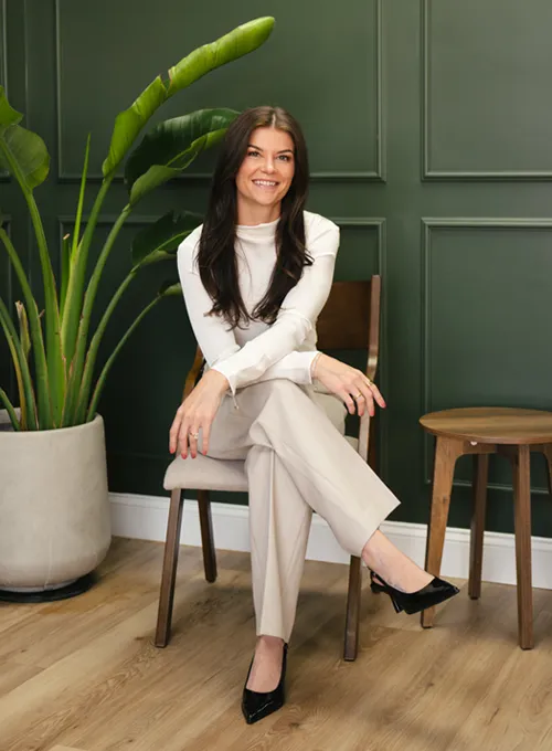 Person seated on a wooden chair in a clinic-style setting